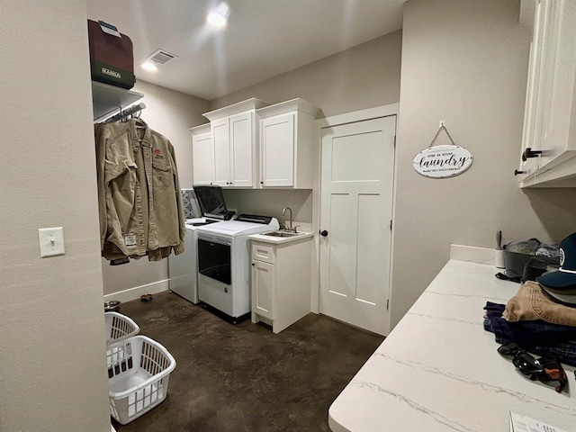 laundry area featuring cabinet space, separate washer and dryer, visible vents, and a sink