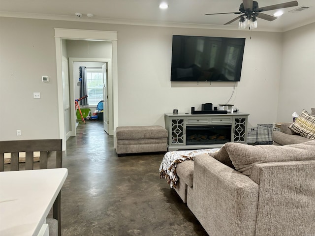 living area with visible vents, concrete flooring, ceiling fan, and ornamental molding