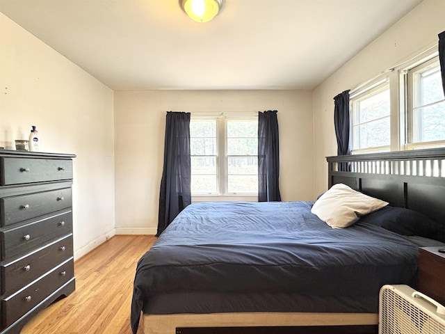 bedroom with baseboards and light wood-style floors