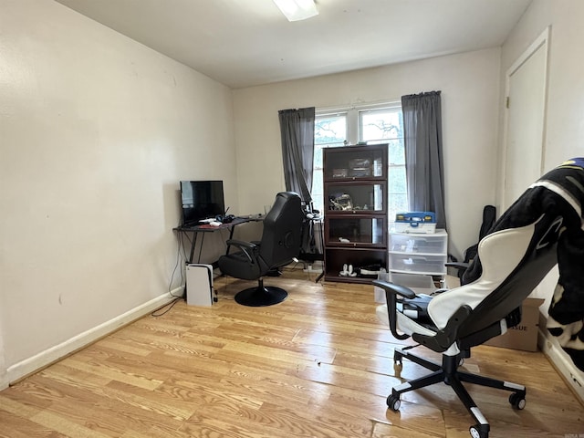 office space featuring baseboards and wood finished floors