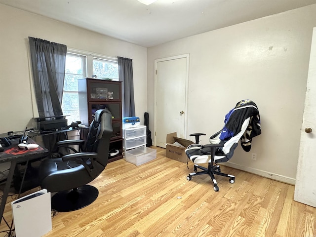 home office featuring wood finished floors and baseboards