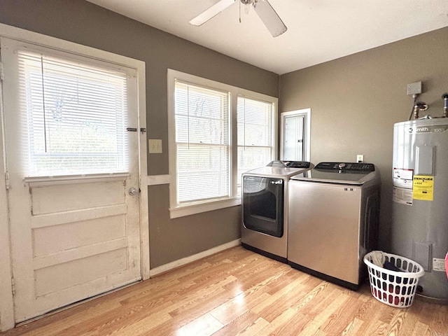 laundry room with laundry area, light wood-style flooring, separate washer and dryer, and water heater