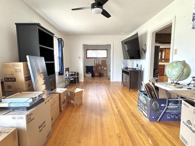 office area with light wood-type flooring and a ceiling fan