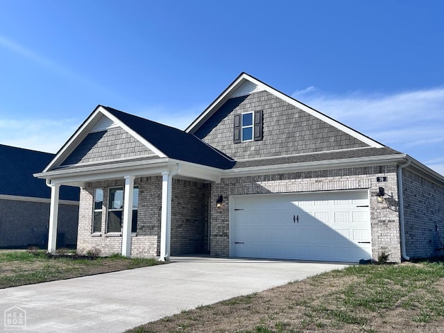 view of front of home with brick siding, an attached garage, and driveway