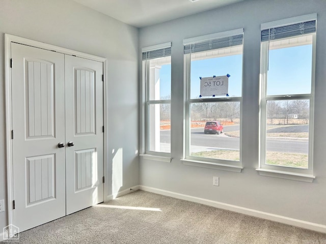 unfurnished bedroom with a closet, baseboards, and carpet