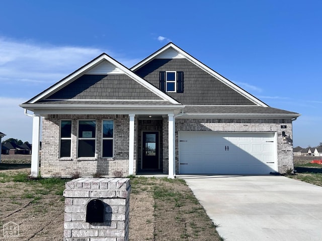 view of front facade featuring a garage, brick siding, and driveway