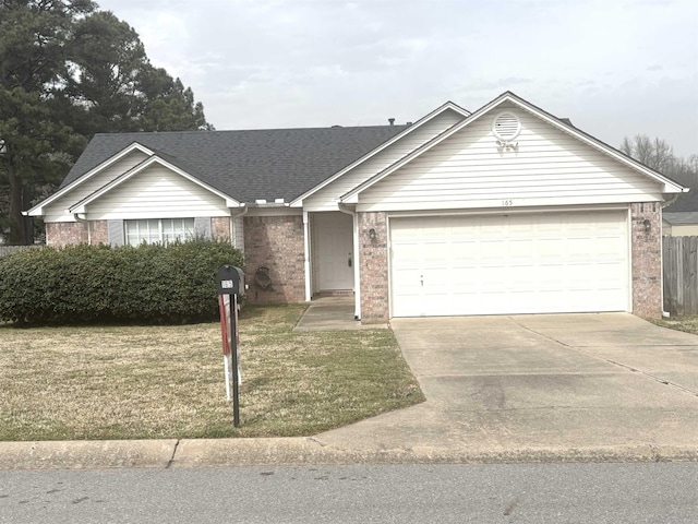 single story home with brick siding, a garage, concrete driveway, and a front lawn