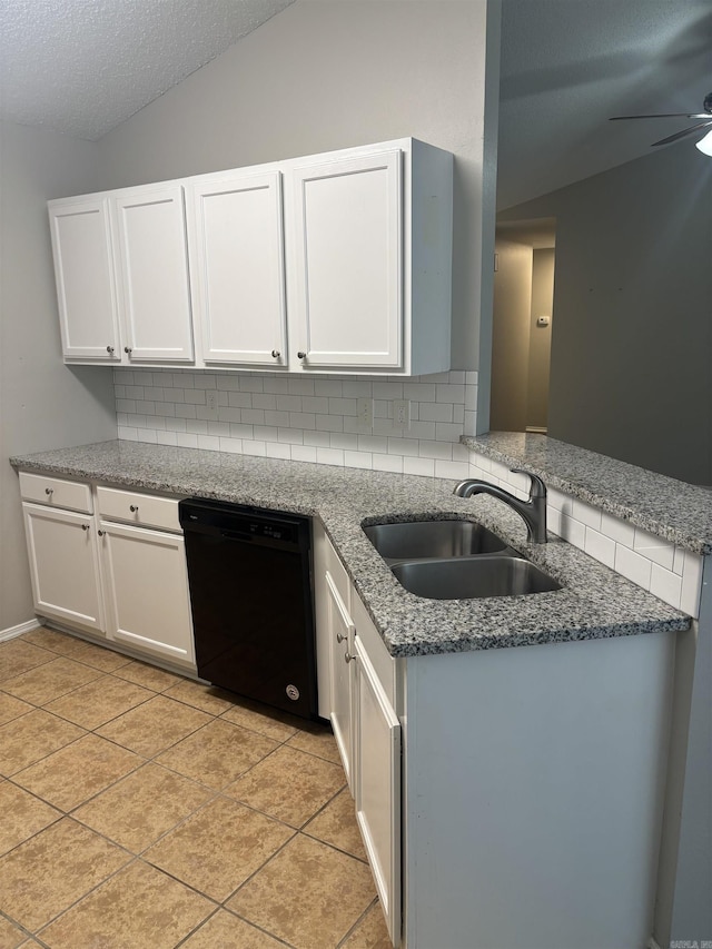 kitchen with ceiling fan, a sink, vaulted ceiling, black dishwasher, and backsplash