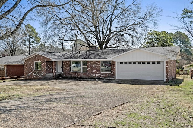 ranch-style house featuring brick siding, driveway, and a garage