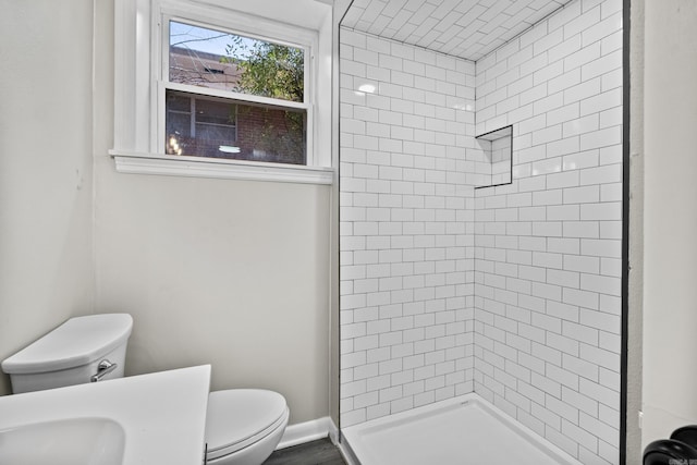 full bathroom with a sink, baseboards, toilet, and a shower stall