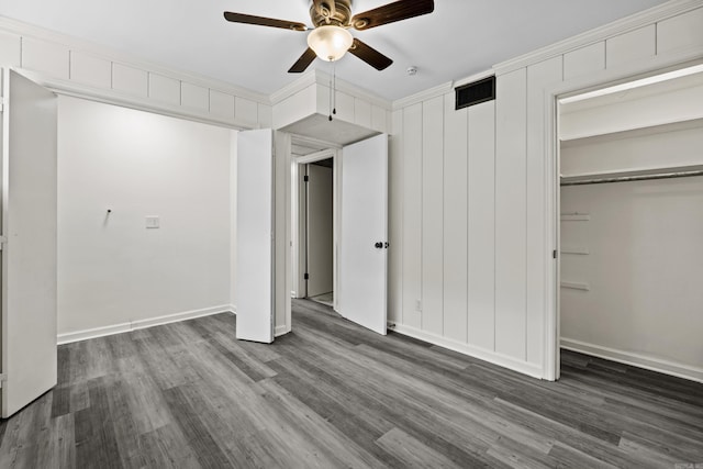 unfurnished bedroom featuring a ceiling fan, wood finished floors, visible vents, and baseboards