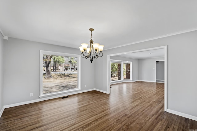 unfurnished dining area with baseboards, visible vents, dark wood-style flooring, ornamental molding, and a chandelier