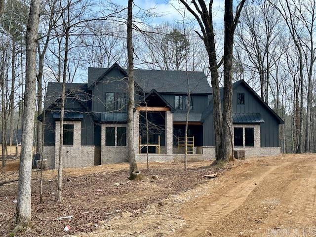 view of front of home with brick siding and board and batten siding