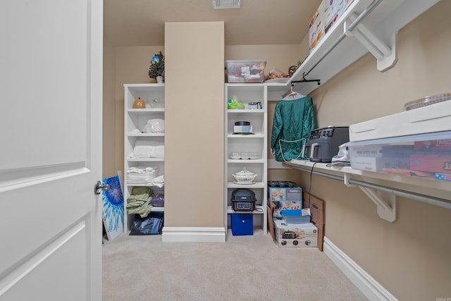 spacious closet featuring visible vents and carpet floors