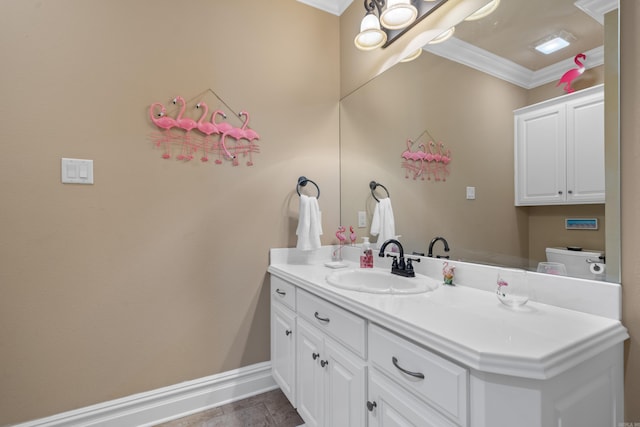 bathroom featuring baseboards, toilet, ornamental molding, and vanity