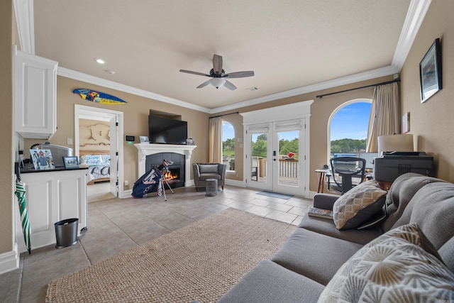 living room featuring crown molding, french doors, baseboards, and ceiling fan