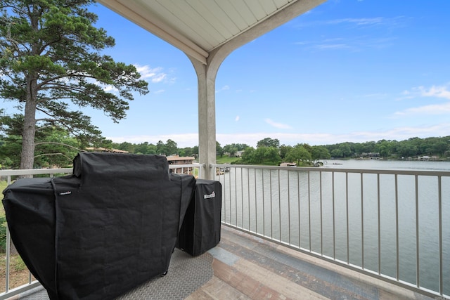 exterior space featuring a water view and a grill