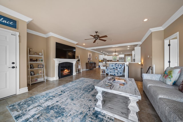 tiled living area with a tiled fireplace, recessed lighting, ceiling fan with notable chandelier, and ornamental molding