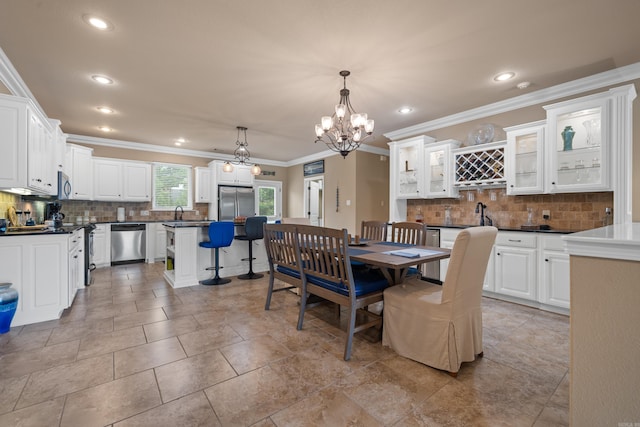 dining space with crown molding, recessed lighting, and a chandelier