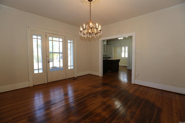 interior space featuring dark wood finished floors, a notable chandelier, baseboards, and ornamental molding