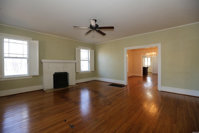 unfurnished living room featuring hardwood / wood-style floors, crown molding, ceiling fan with notable chandelier, and baseboards