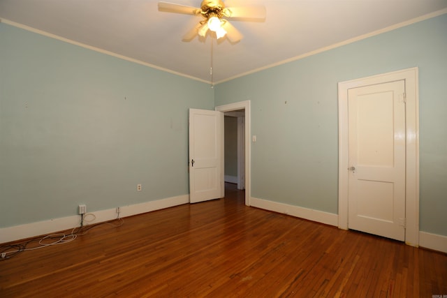 empty room featuring ceiling fan, hardwood / wood-style flooring, baseboards, and ornamental molding