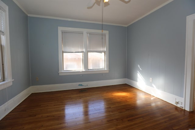 spare room with baseboards, crown molding, a ceiling fan, and wood finished floors