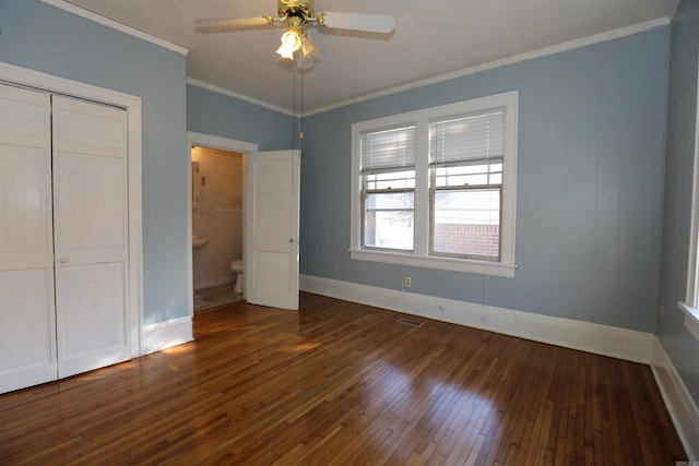 unfurnished bedroom with visible vents, crown molding, baseboards, and hardwood / wood-style flooring