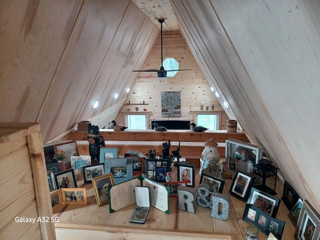 interior space featuring wooden walls and lofted ceiling