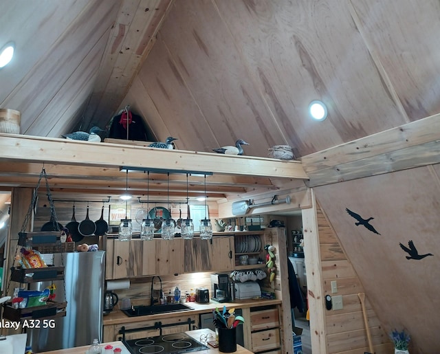 interior space featuring a sink, open shelves, and lofted ceiling