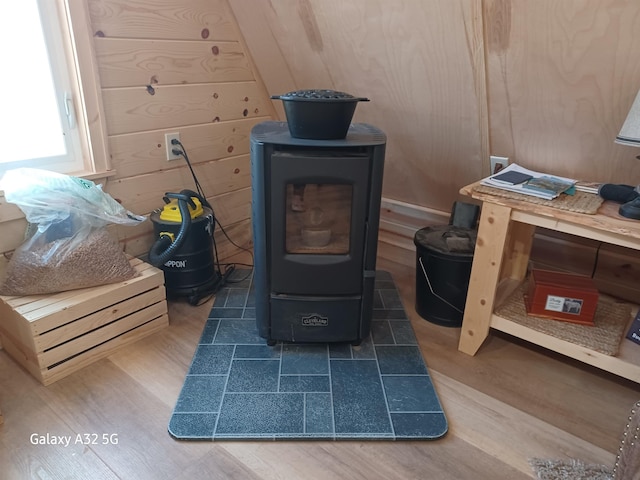 details with wooden walls, a wood stove, and wood finished floors