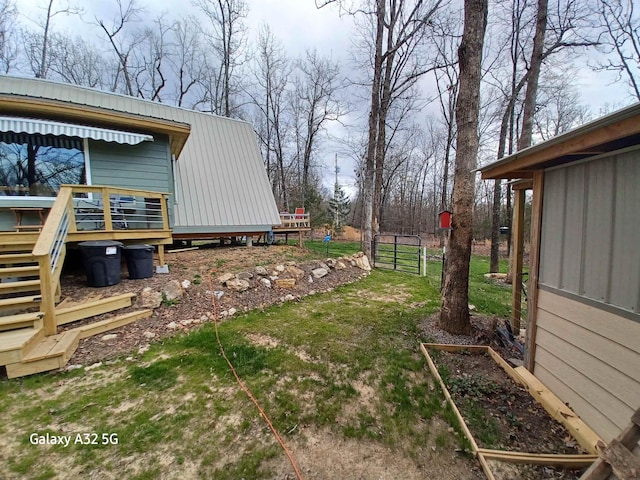 view of yard with a wooden deck and a garden