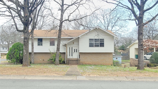 raised ranch with brick siding and entry steps