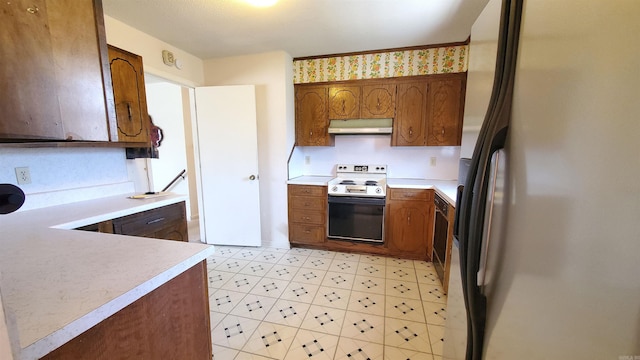 kitchen featuring light countertops, white refrigerator with ice dispenser, under cabinet range hood, and range with electric cooktop