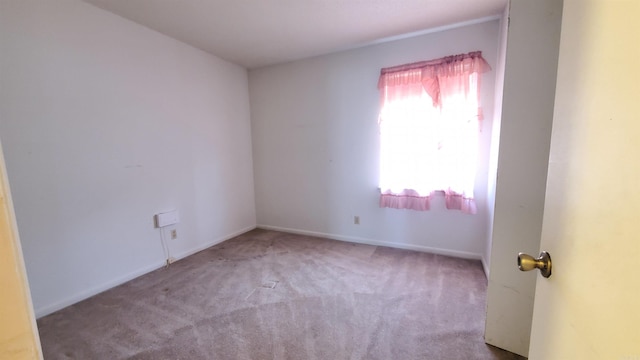 empty room featuring carpet flooring and baseboards