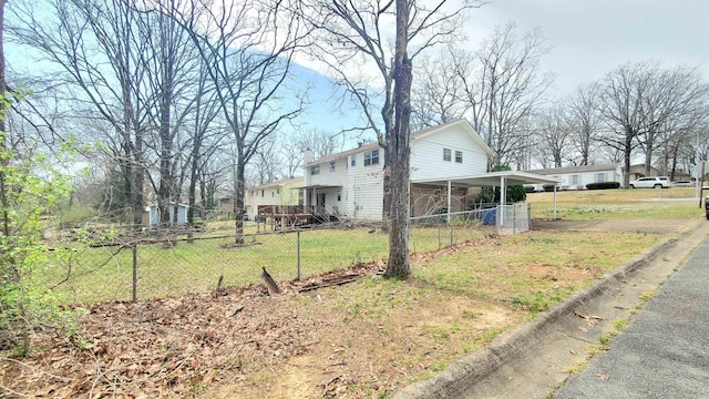 exterior space with a carport, a yard, and fence