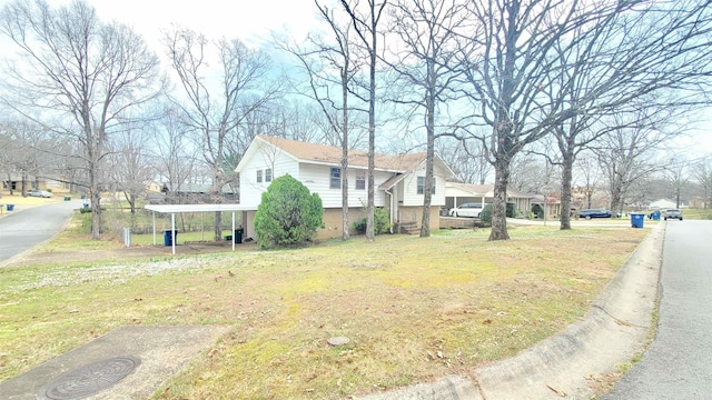 view of home's exterior featuring brick siding and a yard