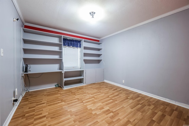 unfurnished bedroom with a textured ceiling, light wood-style floors, baseboards, and ornamental molding