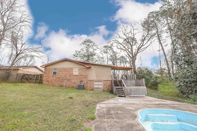 view of side of property with a fenced in pool, fence, stairs, a yard, and a deck