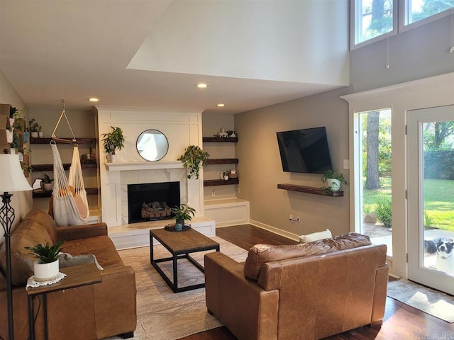 6 Silver Fox Cv, Jacksonville, AR 72076 - living area featuring wood finished floors, baseboards, recessed lighting, a high end fireplace, and a towering ceiling