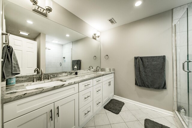 6 Silver Fox Cv, Jacksonville, AR 72076 - bathroom with double vanity, visible vents, a stall shower, and a sink