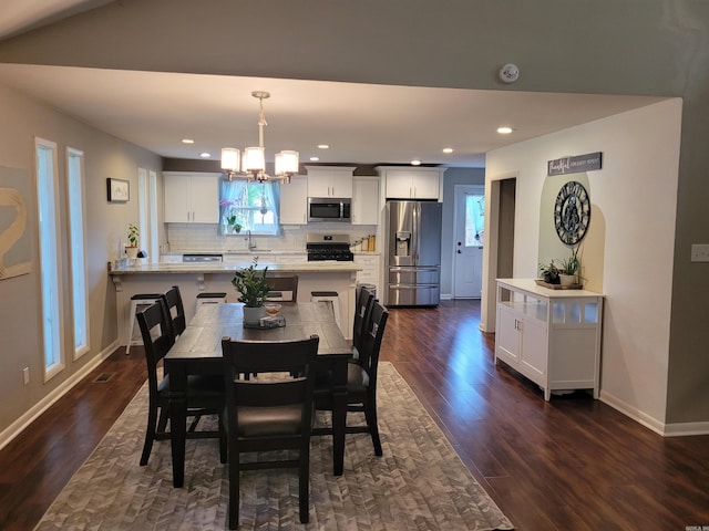 6 Silver Fox Cv, Jacksonville, AR 72076 - dining area featuring dark wood finished floors, an inviting chandelier, recessed lighting, and baseboards