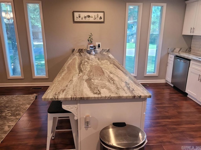 6 Silver Fox Cv, Jacksonville, AR 72076 - kitchen featuring dark wood-style floors, white cabinetry, a breakfast bar, a peninsula, and dishwasher