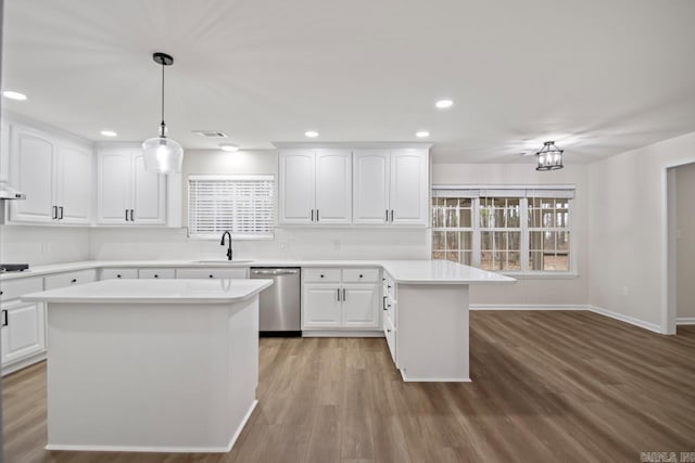 kitchen with a sink, a wealth of natural light, dishwasher, and a peninsula