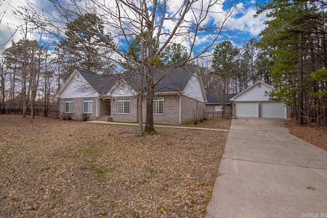 view of front facade with a garage, brick siding, and concrete driveway