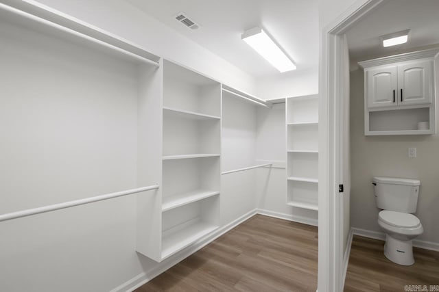 walk in closet with wood finished floors and visible vents