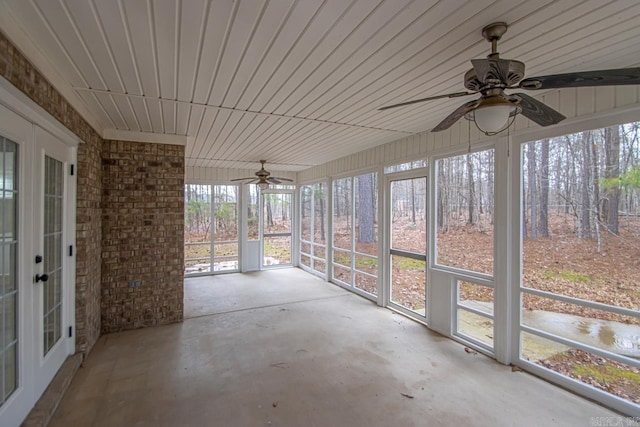 unfurnished sunroom featuring french doors and ceiling fan