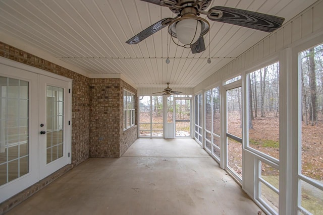 unfurnished sunroom with wooden ceiling, plenty of natural light, french doors, and ceiling fan