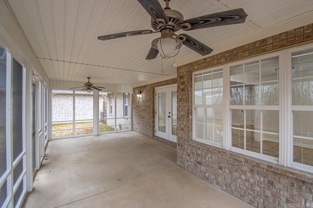 unfurnished sunroom with french doors, wood ceiling, and a ceiling fan