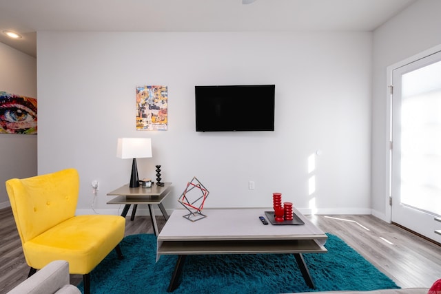 interior space featuring baseboards and wood finished floors